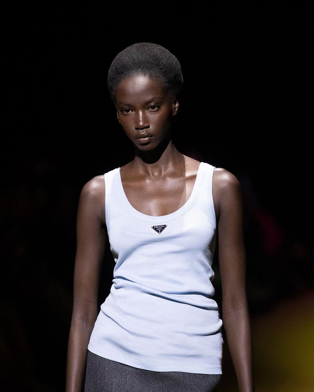 Modelo con camiseta de tirantes en el desfile otoño/incierno 2022/2023 de Prada | Foto: Insatgram @prada