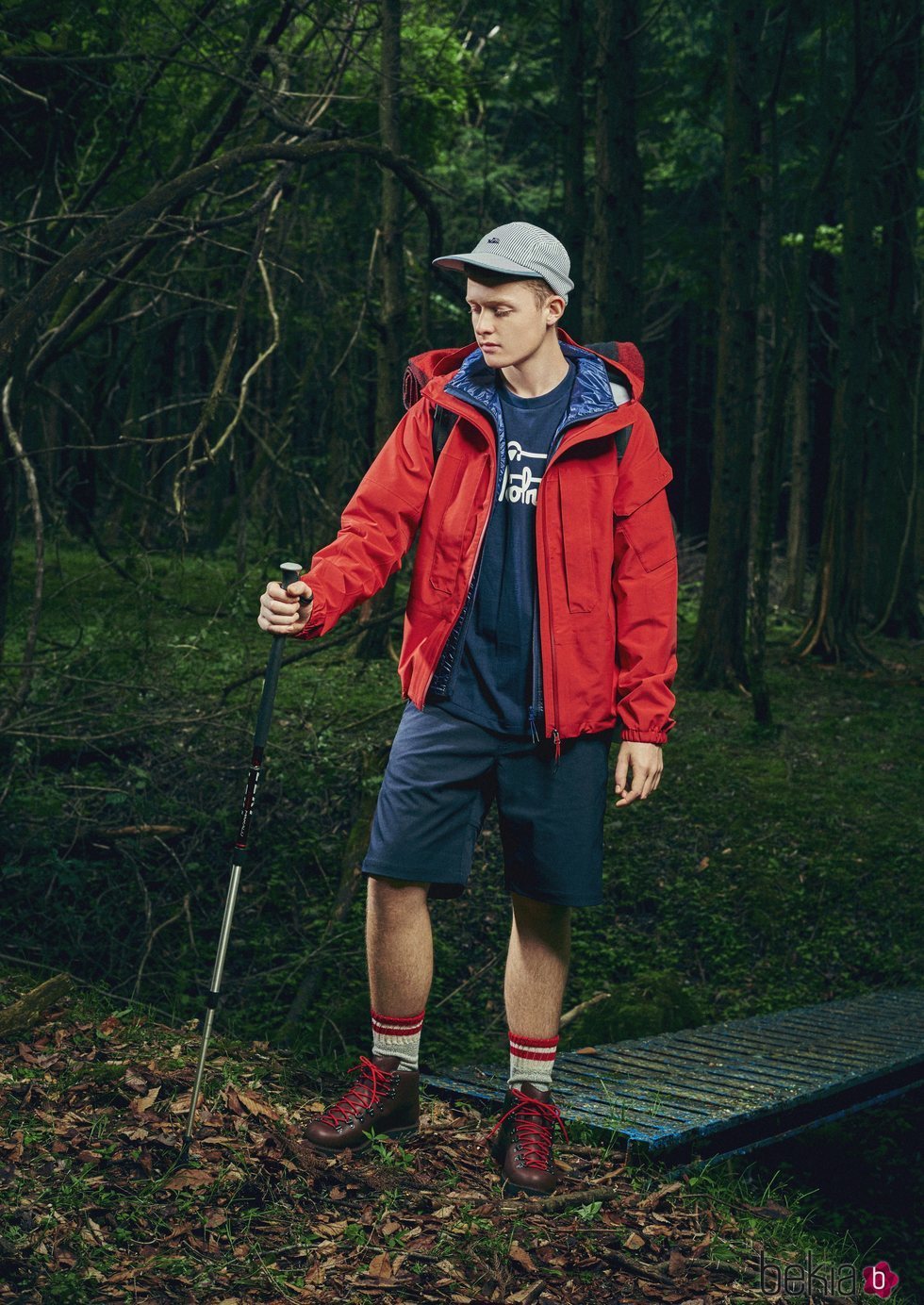 Modelo con un pantalón corto azul y un abrigo rojo de la nueva línea de Outdoor de la nueva colección SS19 de Woolrich