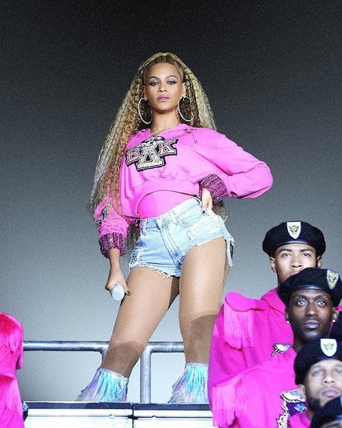 Beyoncé con una sudadera fucsia con capucha de la colección cápsula junto a Balmain 2018