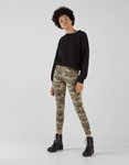 Modelo con unos pantalones con estampado militar de la colección de primavera 2019 de Bershka