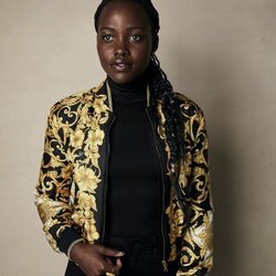 Lupita Nyongo vestida de negro y chaqueta de flores