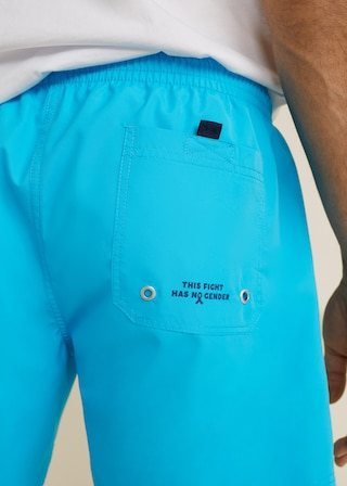 Bañador azul con texto positivo en la parte trasera de Mango Man para ayudar a la lucha contra el cáncer de próstata