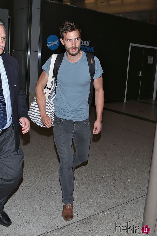 Jamie Dornan con camiseta azul y vaqueros grises