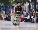 Modelo con camisa con transparencias y falda larga print de Chanel en el desfile Crucero 2017
