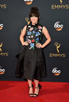 Maisie Williams con un vestido negro de flores en la alfombra roja de los Emmy 2016